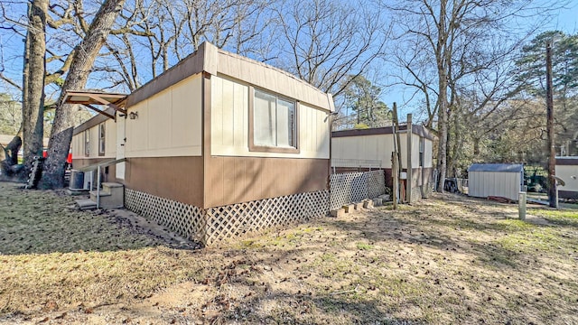 view of side of property featuring a shed