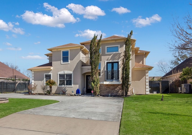 view of front of home featuring a balcony and a front yard