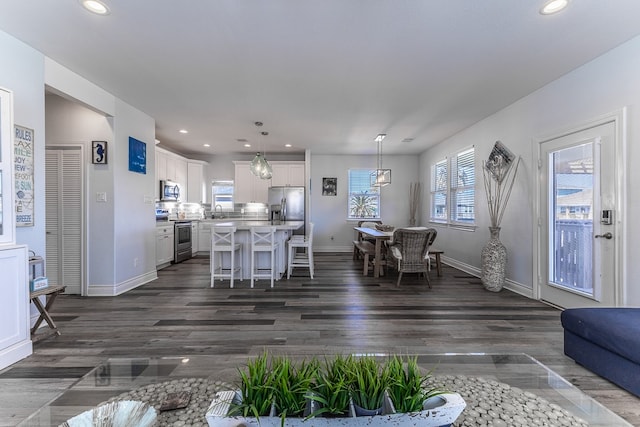 unfurnished living room with sink and dark hardwood / wood-style floors