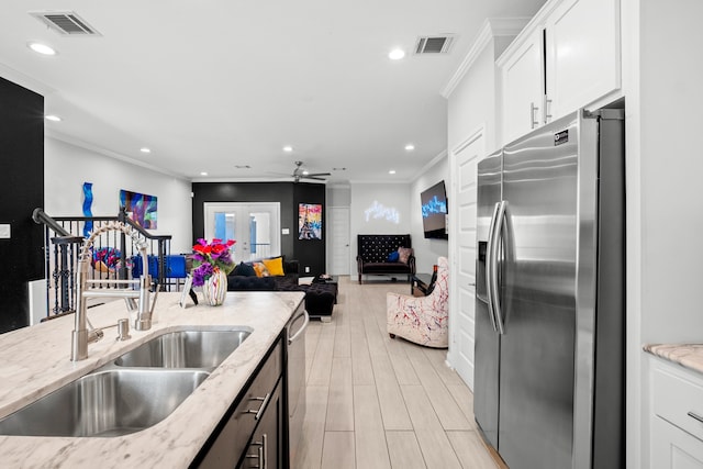 kitchen with white cabinets, light hardwood / wood-style flooring, light stone countertops, ceiling fan, and stainless steel refrigerator with ice dispenser