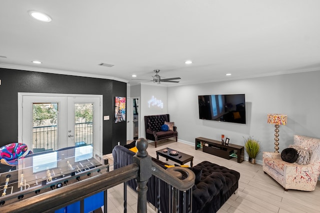 living room featuring light hardwood / wood-style floors, ceiling fan, french doors, and crown molding