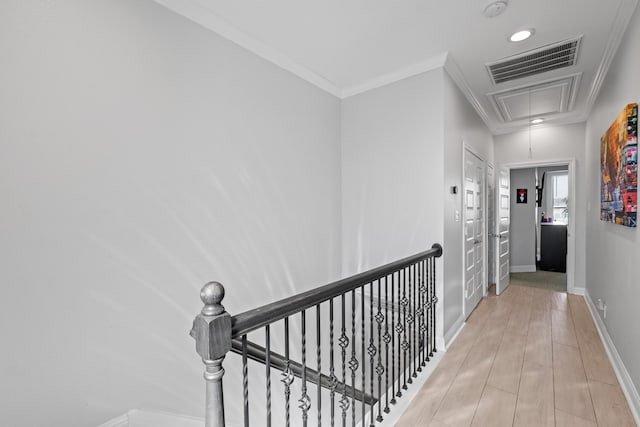 hall featuring ornamental molding and light hardwood / wood-style floors