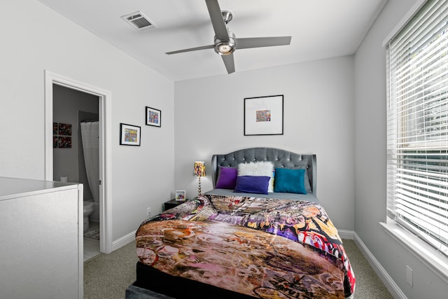 carpeted bedroom featuring ensuite bath and ceiling fan