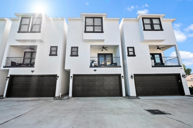 view of property with a balcony and a garage