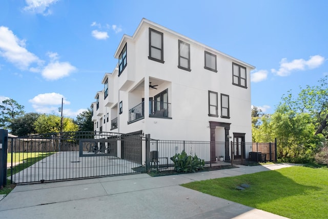 view of front of home featuring a balcony and a front yard