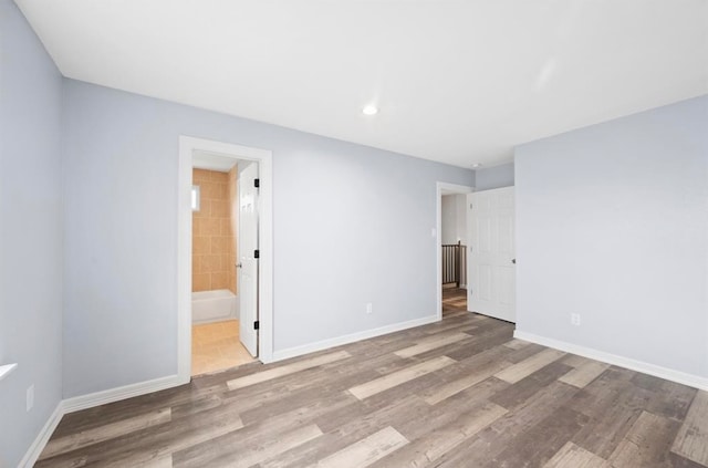 unfurnished room with hardwood / wood-style flooring