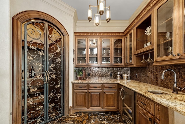 bar with sink, backsplash, light stone counters, ornamental molding, and beverage cooler