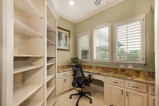 office featuring ornamental molding, light tile floors, and built in desk