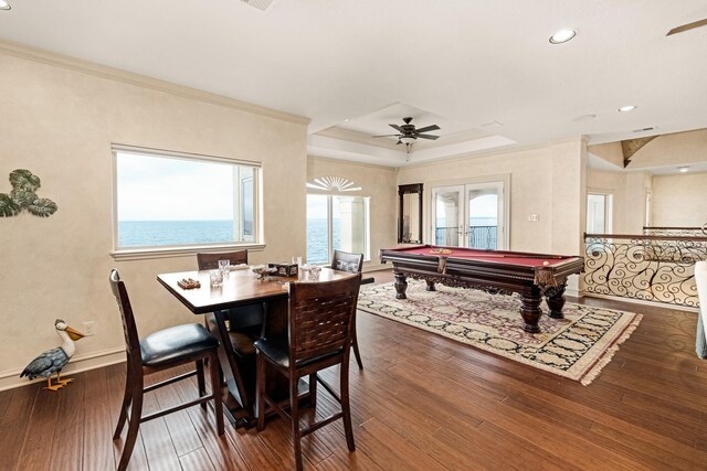 rec room featuring billiards, a tray ceiling, ceiling fan, and dark wood-type flooring