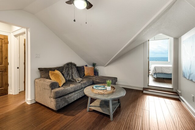 living room with lofted ceiling, a textured ceiling, dark hardwood / wood-style floors, and ceiling fan