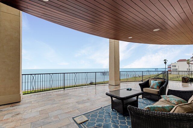 view of terrace with a water view