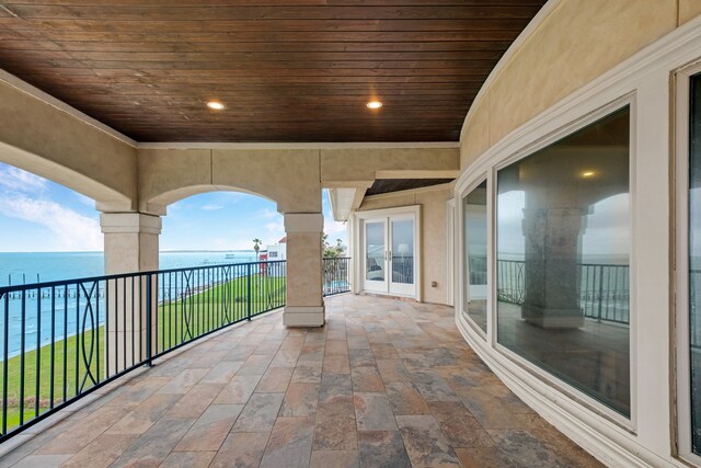 view of terrace featuring a balcony and a water view