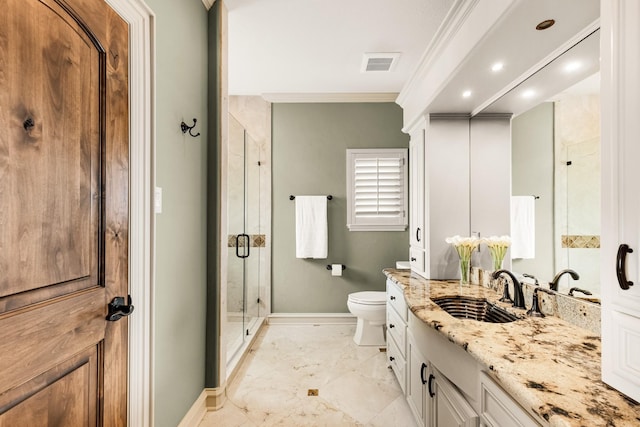 bathroom with vanity, crown molding, a shower with door, and toilet