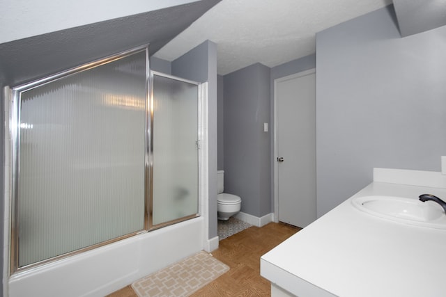 full bathroom featuring toilet, vanity, bath / shower combo with glass door, and parquet flooring