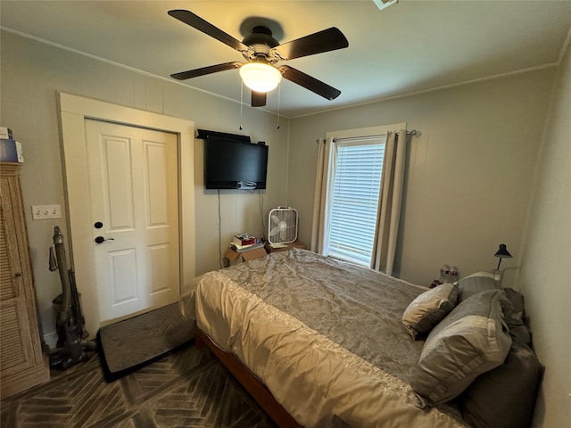 bedroom with ceiling fan and parquet floors