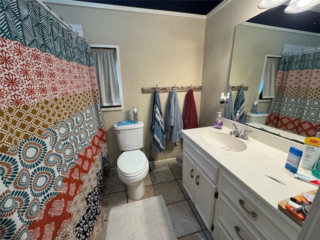 bathroom featuring tile floors, toilet, and vanity