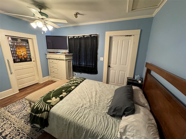 bedroom featuring dark hardwood / wood-style floors, ceiling fan, and ornamental molding