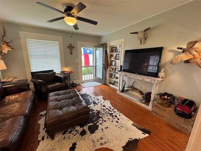 living room featuring hardwood / wood-style floors and ceiling fan