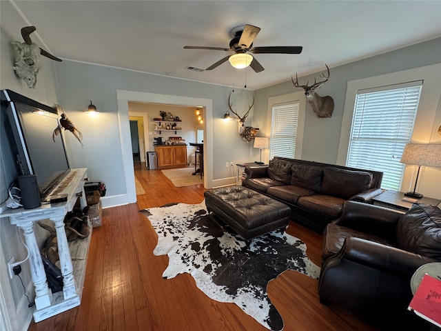 living room featuring hardwood / wood-style flooring and ceiling fan