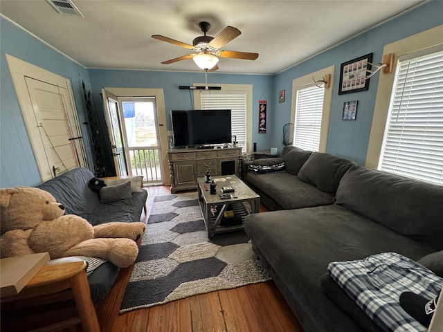 living room featuring hardwood / wood-style floors and ceiling fan