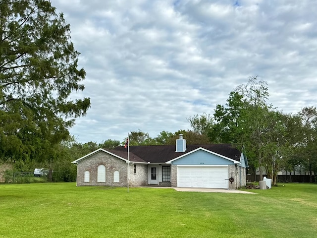 view of front of property featuring a garage and a front lawn