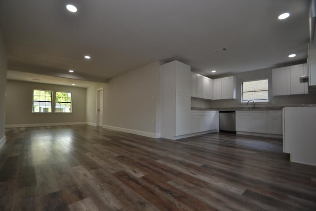 unfurnished living room featuring dark hardwood / wood-style flooring and sink