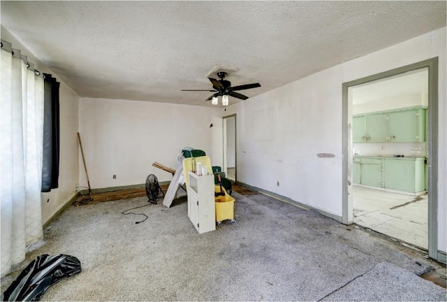 interior space with a textured ceiling and ceiling fan