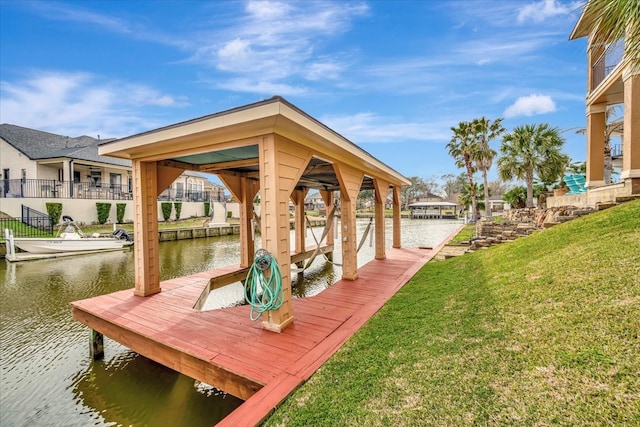 view of dock featuring a lawn and a water view