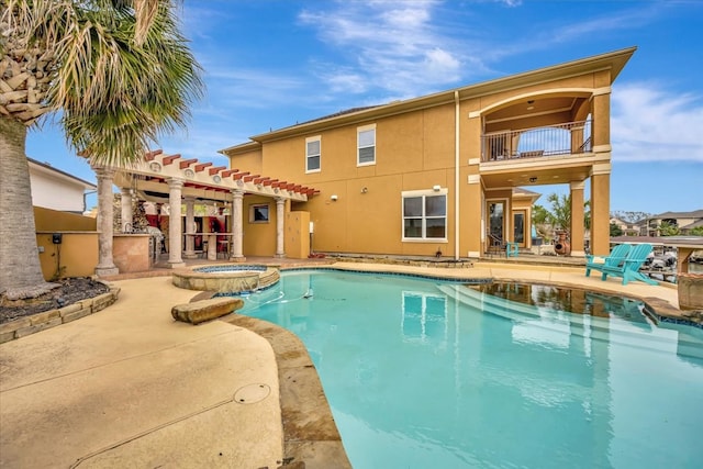 view of swimming pool with a patio and an in ground hot tub