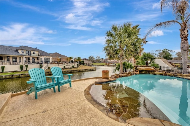 view of swimming pool with a water view and a patio area