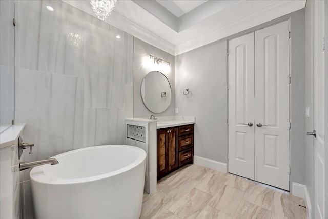 bathroom featuring vanity, crown molding, and a washtub