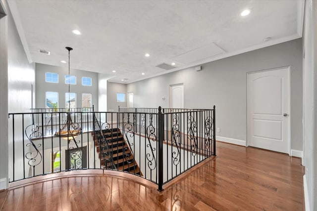 hall featuring ornamental molding and hardwood / wood-style floors