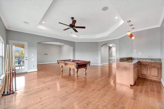 playroom with billiards, a raised ceiling, light wood-type flooring, ornamental molding, and sink