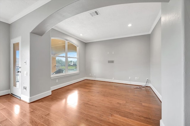 unfurnished living room featuring light hardwood / wood-style flooring and ornamental molding