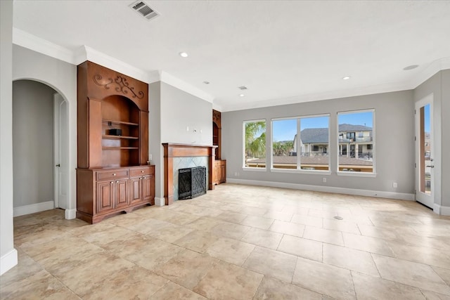 unfurnished living room featuring built in features, a high end fireplace, and crown molding