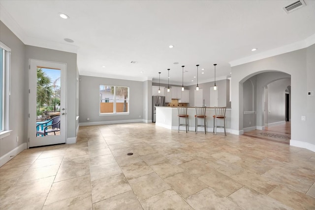 unfurnished living room with crown molding