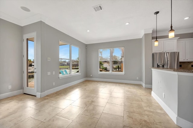 unfurnished living room featuring ornamental molding and light tile patterned floors