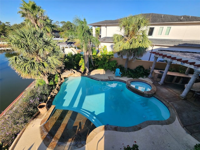 view of swimming pool with a patio, an in ground hot tub, and a water view