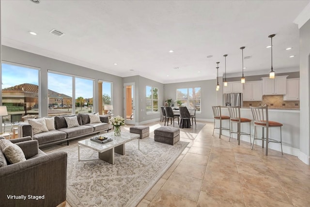 tiled living room featuring ornamental molding and a wealth of natural light