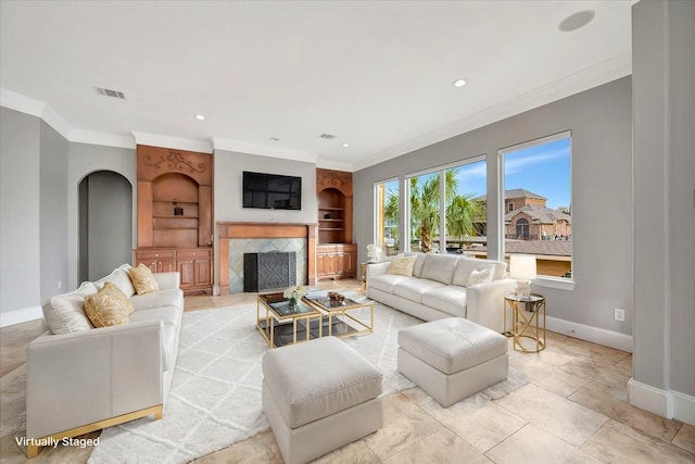 living room with crown molding and built in shelves