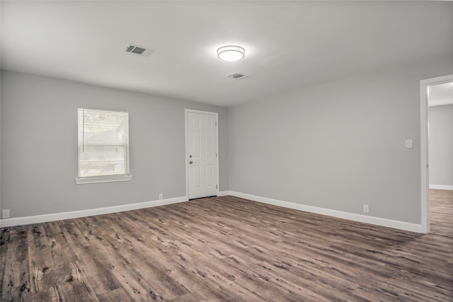 unfurnished room with dark hardwood / wood-style floors