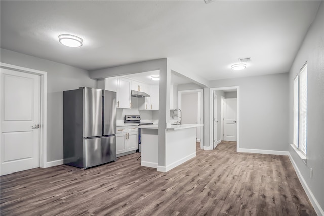 kitchen featuring white cabinets, plenty of natural light, stainless steel appliances, and wood-type flooring