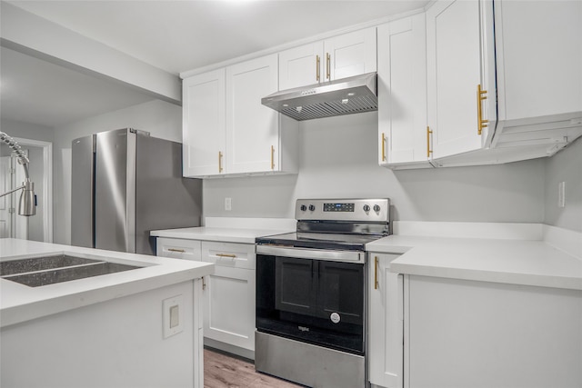 kitchen with light hardwood / wood-style flooring, sink, stainless steel appliances, and white cabinets