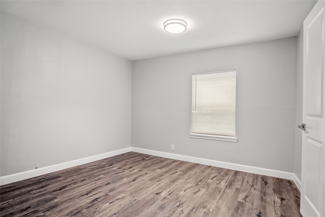 unfurnished room with dark wood-type flooring