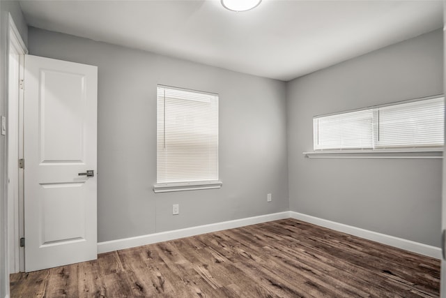 empty room with dark hardwood / wood-style floors