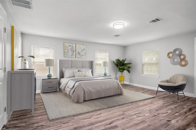 bedroom featuring multiple windows and dark hardwood / wood-style floors