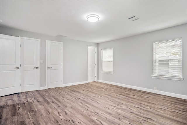 unfurnished room with plenty of natural light and light wood-type flooring