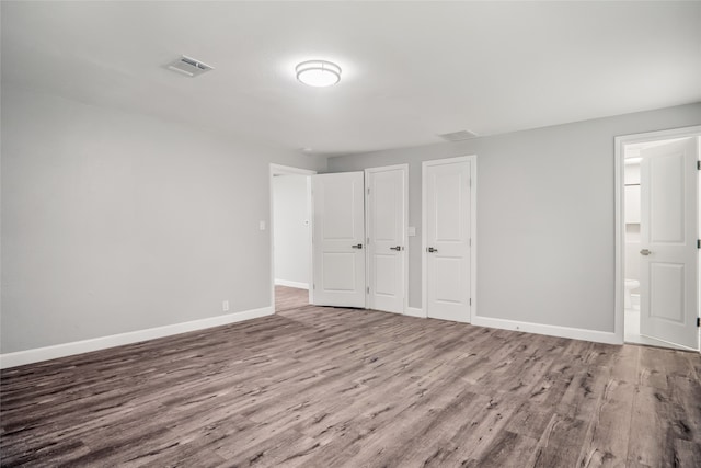 spare room with hardwood / wood-style floors