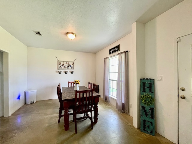 dining space with a textured ceiling