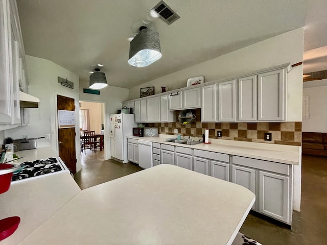 kitchen featuring white appliances, sink, tasteful backsplash, and custom exhaust hood